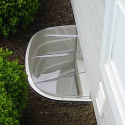 A vinyl basement window and covered window well in Glen Allen