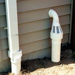 A grated sump pump discharge line fitting in Sandston