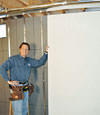 Installing wall panels on top of our basement wall insulation in Toano