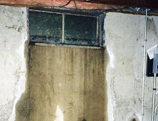 Water pouring out from a basement window in Midlothian
